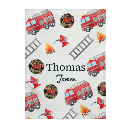 This personalized baby name blanket, has fire trucks, ladders, fire hydrants and fire on it. Thomas James is the name in the middle of the blanket. 